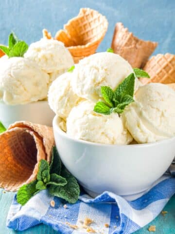 vanilla ice cream scoops in a white bowl.