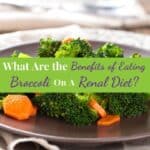 Steamed broccoli with sliced carrots on plate