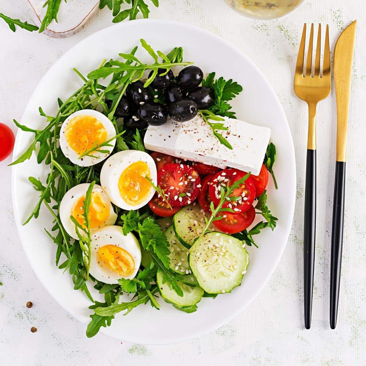 Breakfast. Greek salad and boiled eggs. Fresh vegetable salad with tomato, cucumbers, olives, arugula and feta cheese