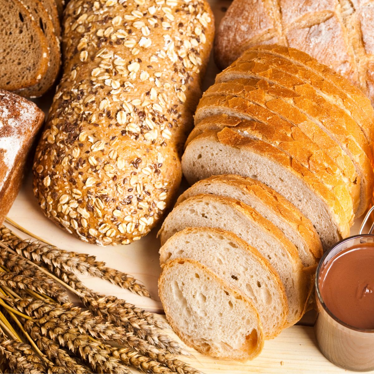 Different loaves of tasty bread with wheat, flour and gluten.