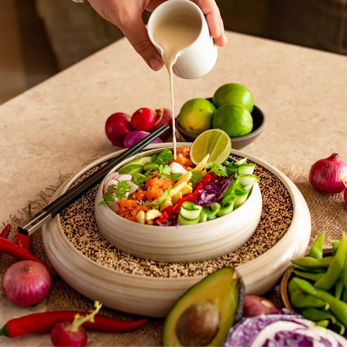 pouring salad dressing onto a lettuce salad.