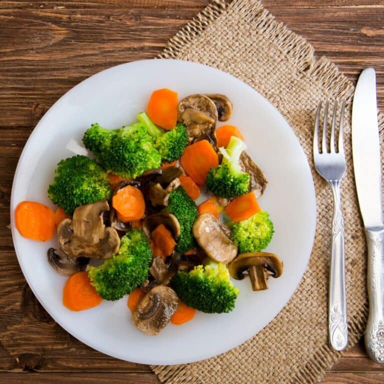 Delicious vegetarian food in a dish vegetable meal. Broccoli, carrots and mushrooms.