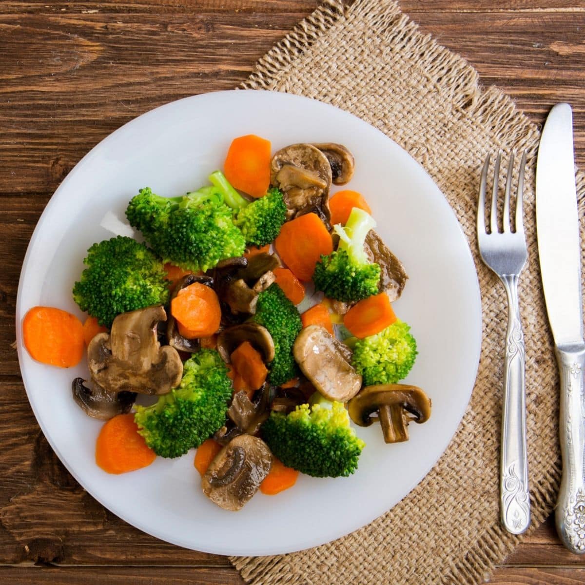 Delicious vegetarian food in a dish vegetable meal. Broccoli, carrots and mushrooms.