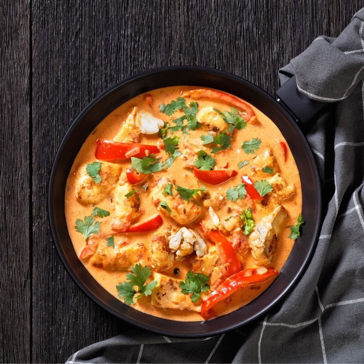 Fish Stew cooked in rich and fragrant sauce of coconut milk, crushed tomatoes and sweet red pepper topped.
