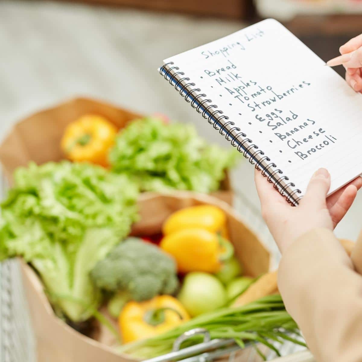 Woman Holding Shopping List in Supermarket