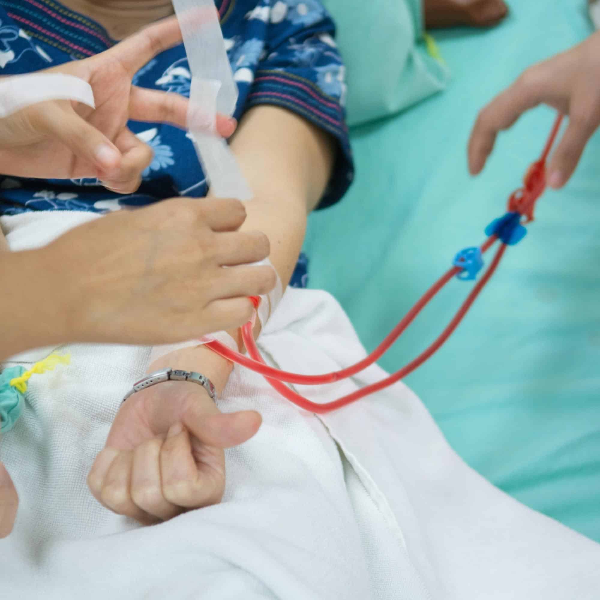 Hemodialysis, hand putting tapes on Tube