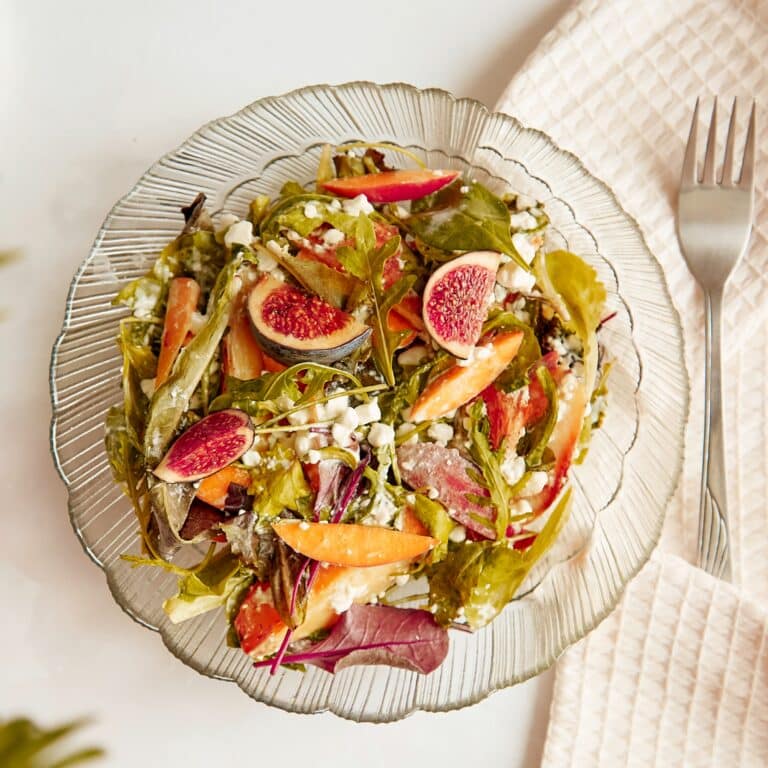 Salad of batata, arugula, grain rustic cheese, figs and peach. Healthy dish, vegan fresh salad, easy recipe.