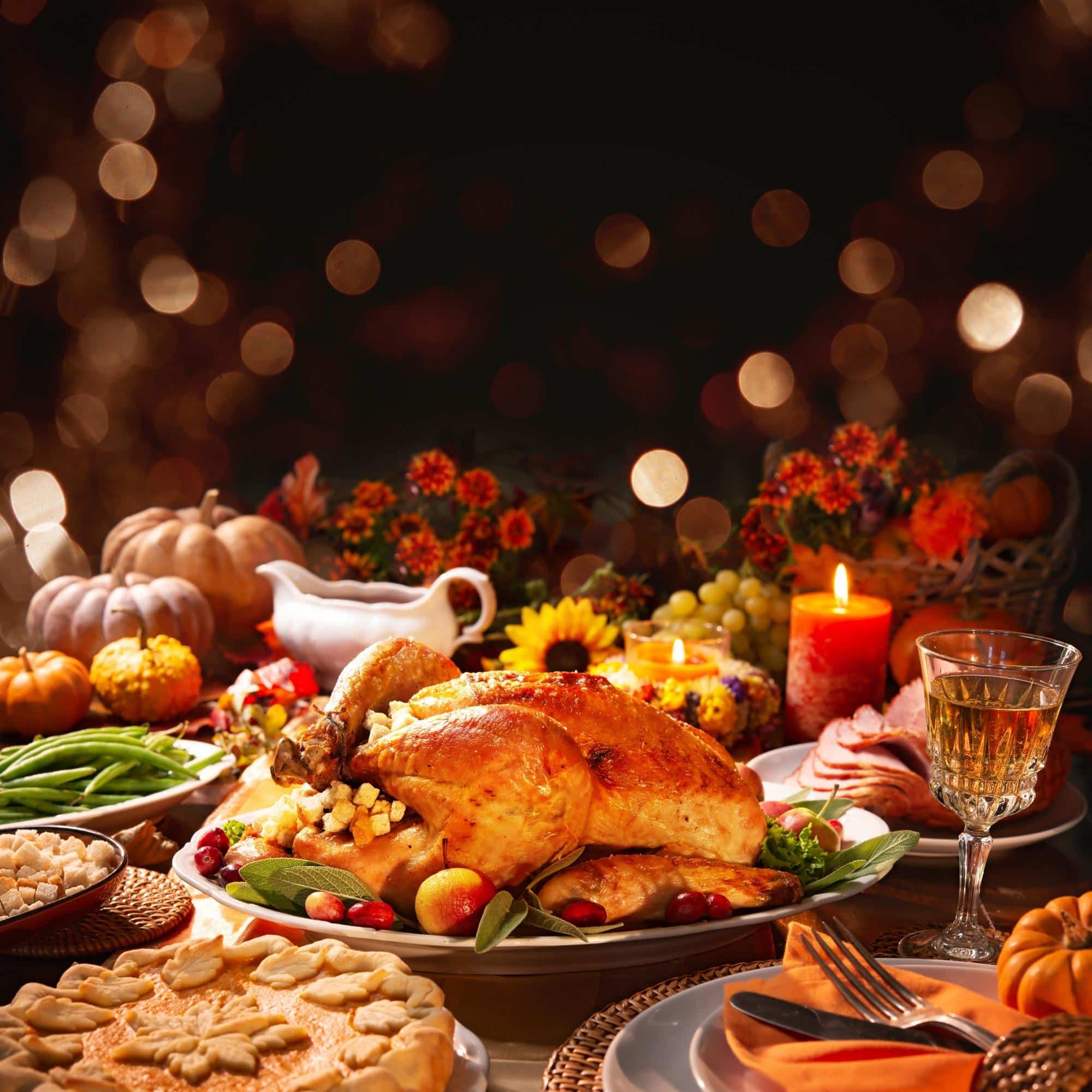 What To Eat On Thanksgiving With Ckd (with Info Sheet) thanksgiving dinner with food on a wooden table with bokeh lights in the background