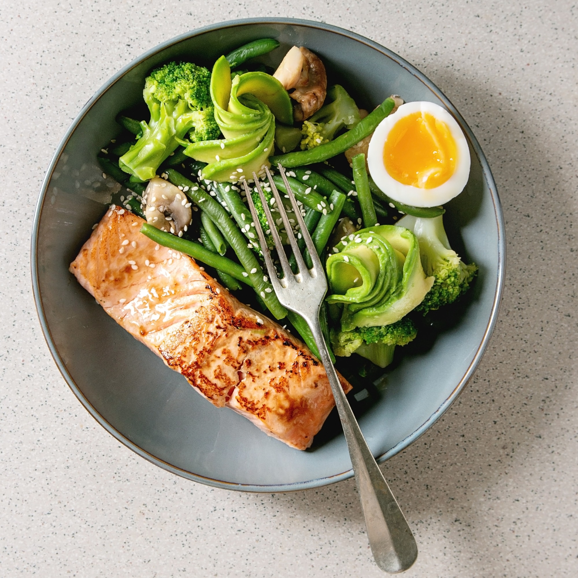 a plate of healthy vegetables food on a table with a fork