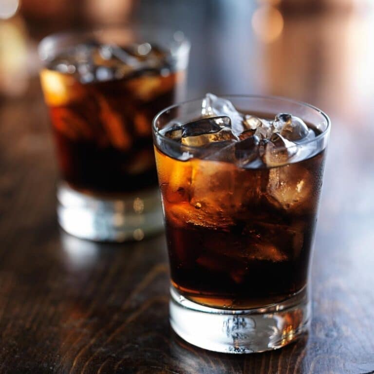 Two glasses of Cold Fizzy Cola Soda with ice cubes
