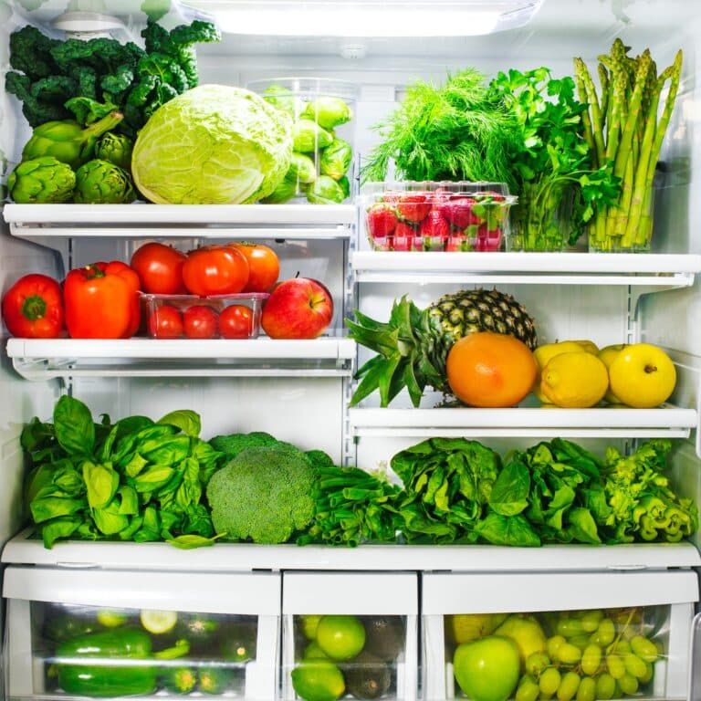 an open refrigerator full of fresh fruits and vegetables.