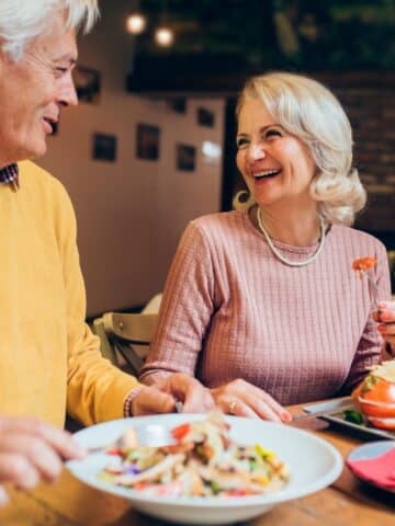 elderly couple enjoying a meal in a restaurant