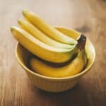 a bunch of bananas sitting in a bowl on a table