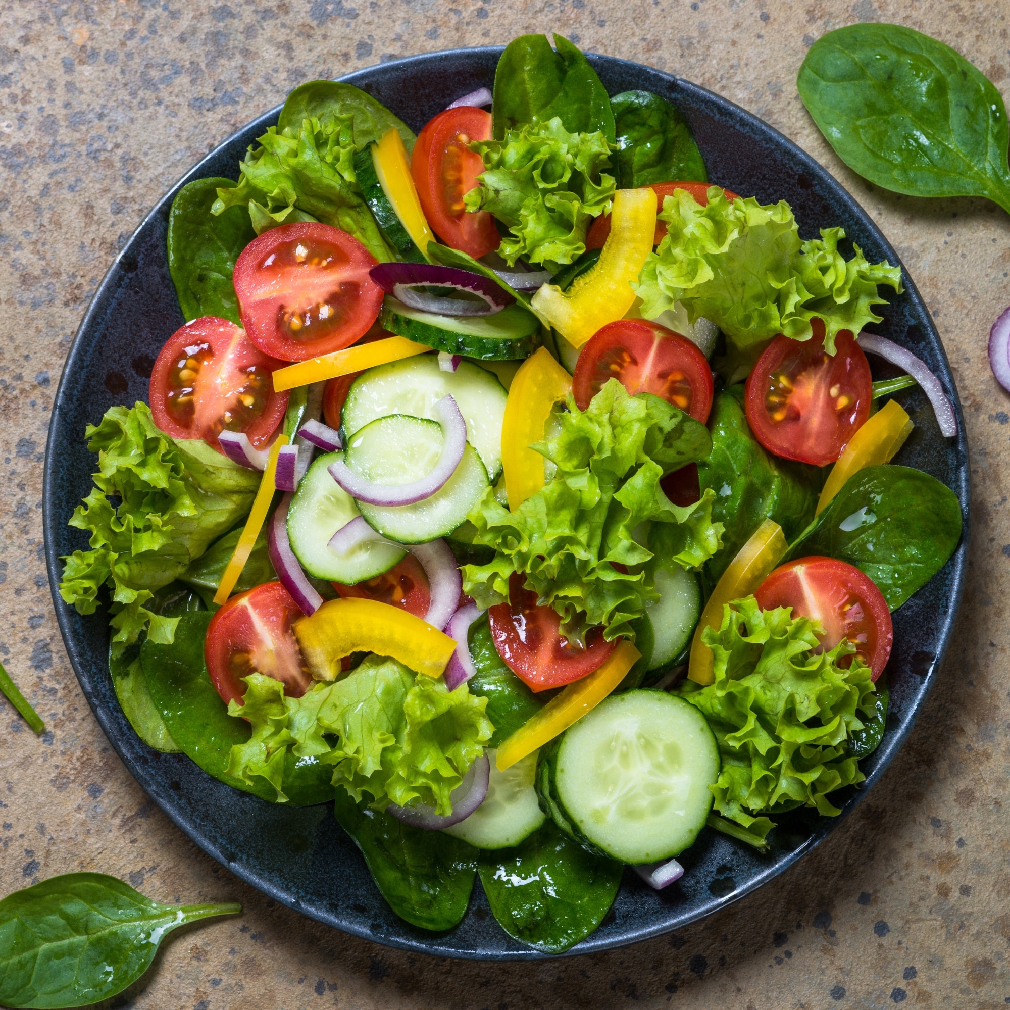 salad with tomatoes, cucumbers, peppers and onions on a plate