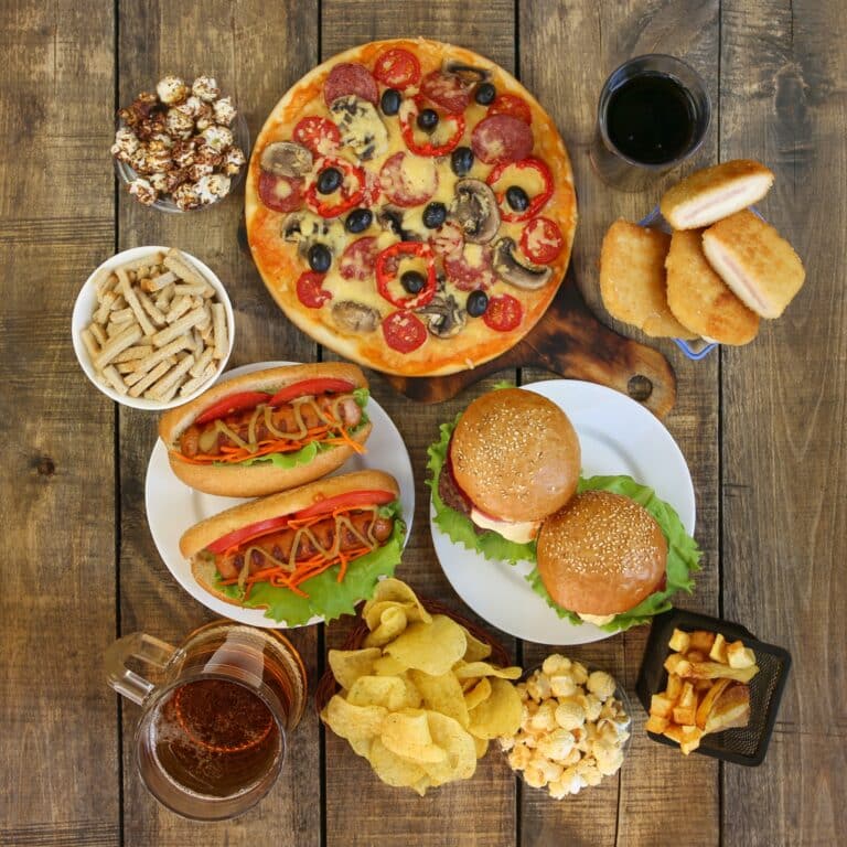 Fast food on old wooden background.