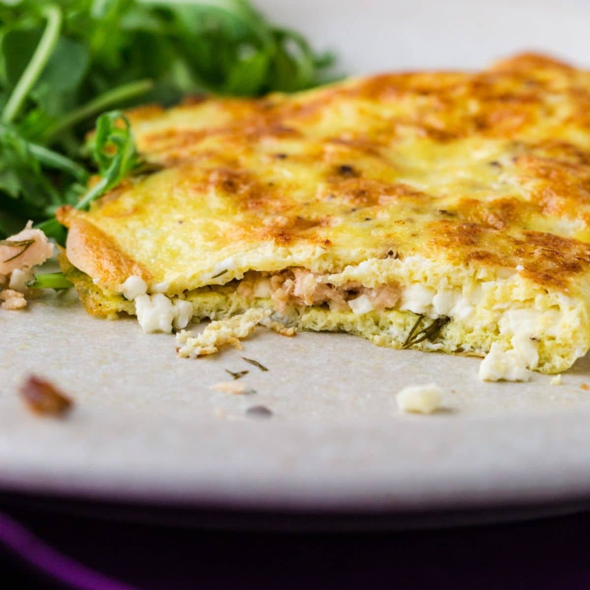 close up of inside of omelette showing feta and salmon inside.