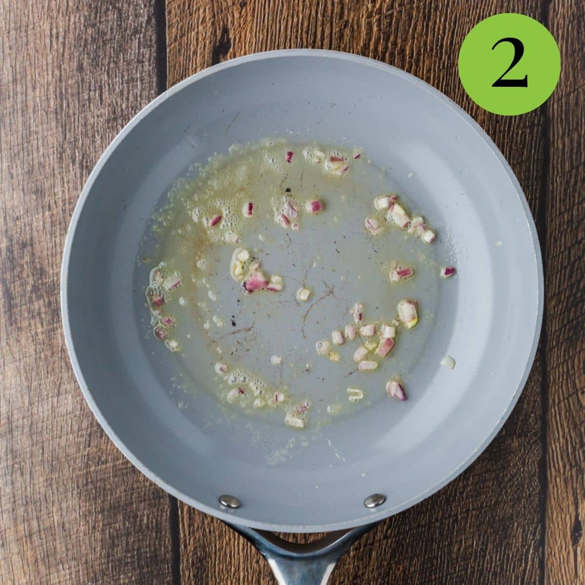 Melt butter in a non-stick skilled over medium-low heat and tilting the pan to ensure the entire pan is coated. Add onions and cook for 1 minute.