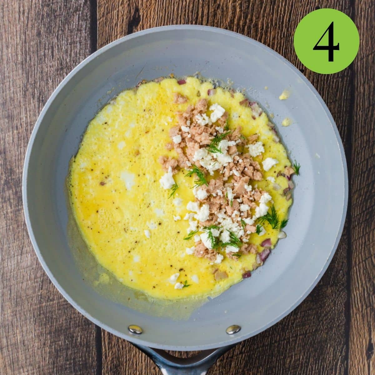 Sprinkle the salmon, feta and dill over one half of the eggs. Cook for 1 minute.