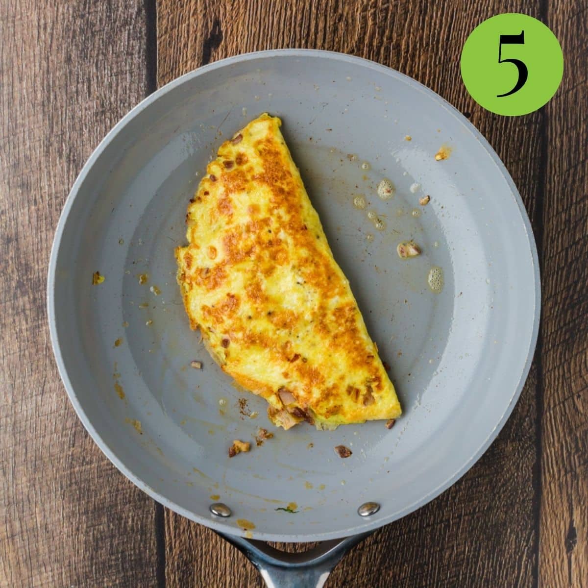 flip the omelette over and then cook until complete.