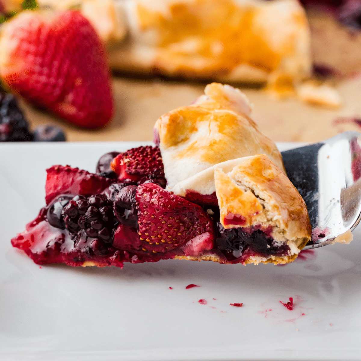 Mixed Berry Galette on a metal fork ready for someone to take a bite.