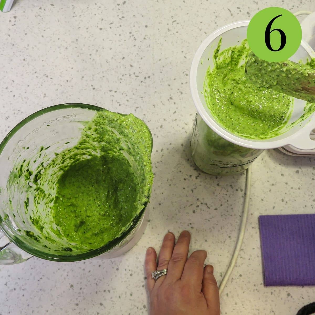 Pesto being added to a storage jar. 