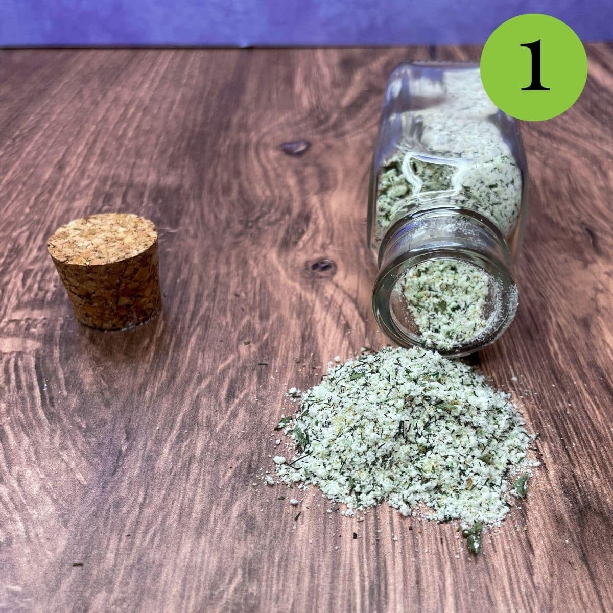 Low sodium ranch seasoning spilled out onto the counter from a clear bottle. 