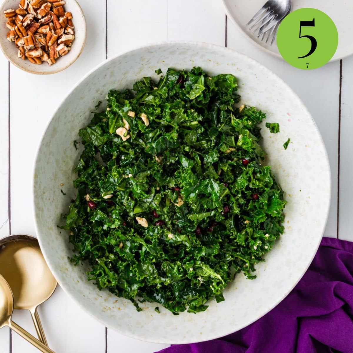 mixture of kale salad with pomegranates in bowl